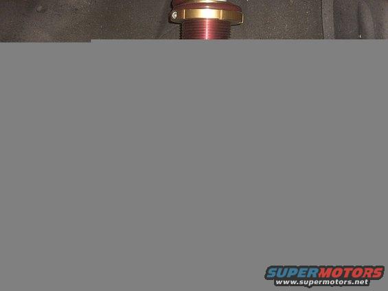 close-up of a red and gold suspension coilover assembly